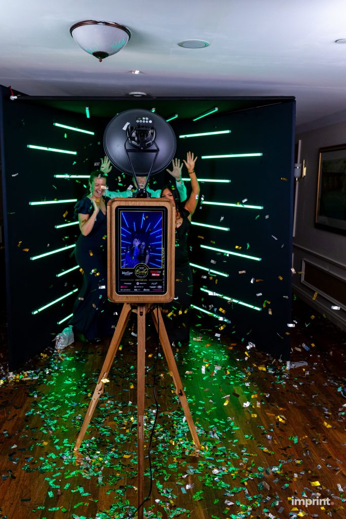 Ladies at a party getting their photos taken on the Everybooth in the vogue booth hire experience